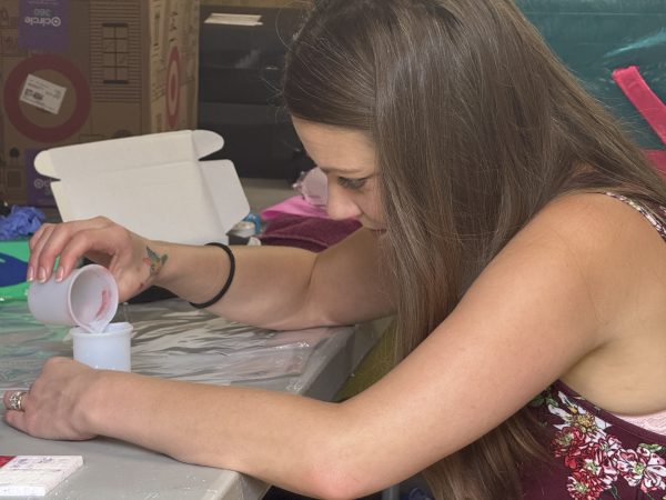 Kalli Fedusenko, founder of Savvy Advisor Marketing building Kevin Bacon mascot
